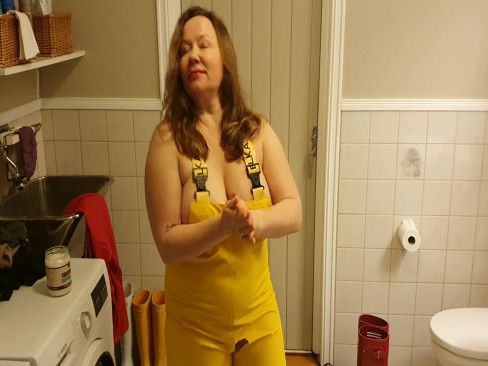Greasing up big tits in oil in rainpants and rubber boots | PORNO.NU